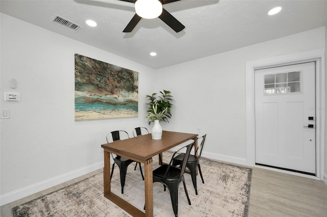 dining space featuring ceiling fan and light wood-type flooring