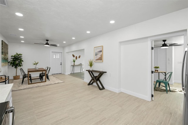 interior space with light wood-type flooring and ceiling fan