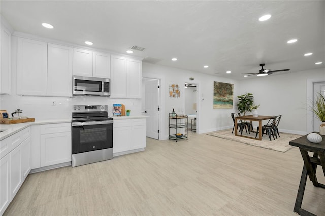 kitchen featuring white cabinetry, ceiling fan, tasteful backsplash, and appliances with stainless steel finishes