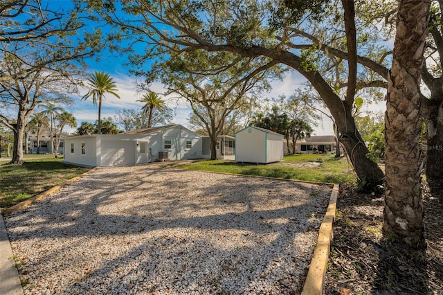 view of front facade featuring a front lawn and a storage shed