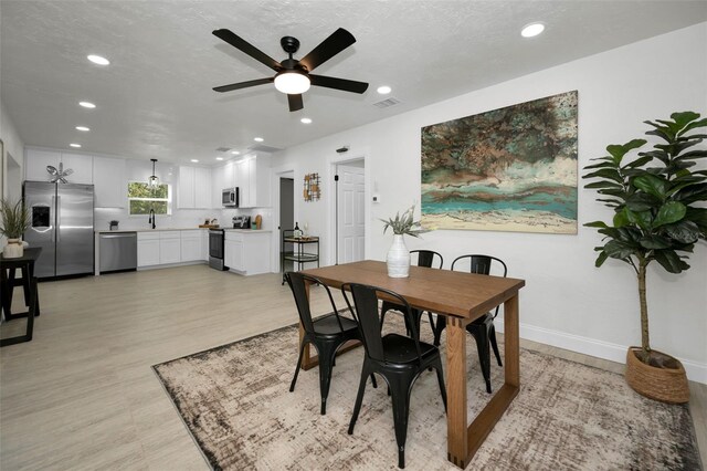 402 Pineapple St, Tarpon Springs, FL 34689 - dining room featuring visible vents, recessed lighting, and light wood-style flooring