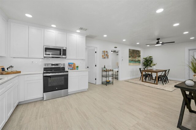 402 Pineapple St, Tarpon Springs, FL 34689 - kitchen featuring ceiling fan, visible vents, light countertops, stainless steel appliances, and recessed lighting