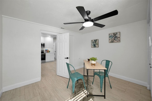 402 Pineapple St, Tarpon Springs, FL 34689 - dining space featuring ceiling fan, visible vents, baseboards, and light wood finished floors