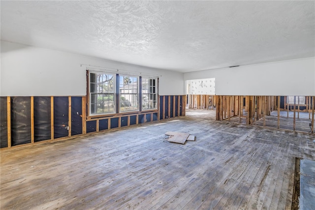 interior space with wood-type flooring and a textured ceiling