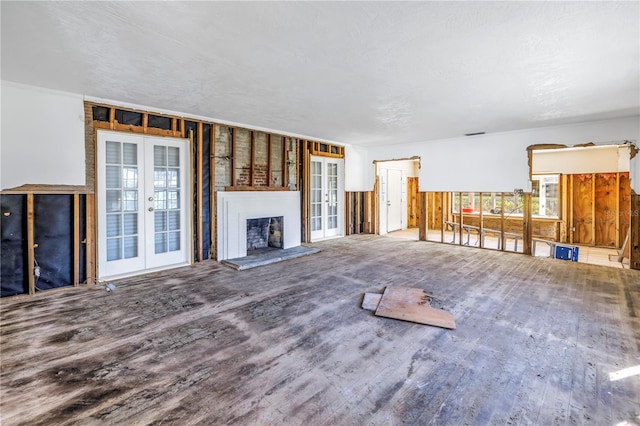 unfurnished living room featuring french doors and wood-type flooring