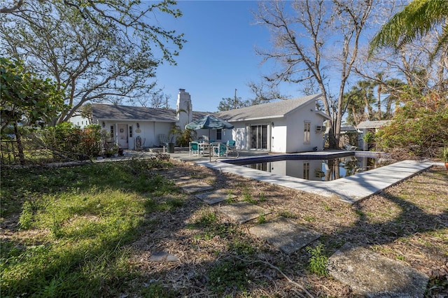 back of property with a patio