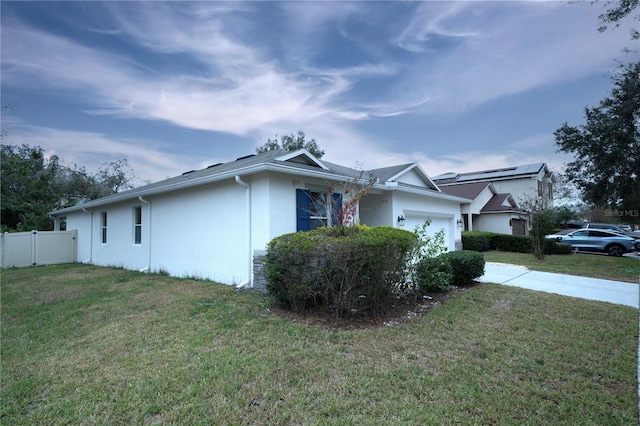 view of home's exterior with a lawn and a garage