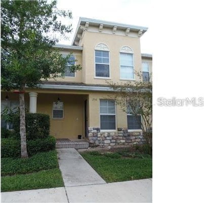 view of front of home featuring stone siding and stucco siding