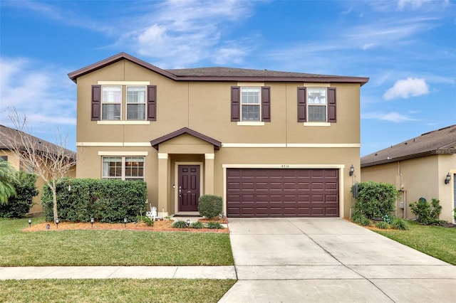 front of property featuring a front yard and a garage