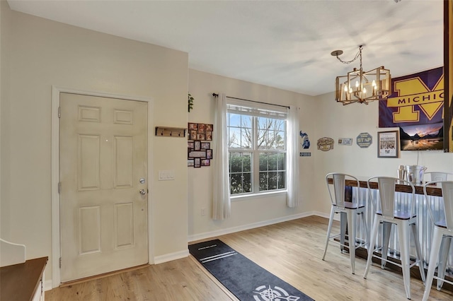 foyer featuring light hardwood / wood-style flooring and a notable chandelier