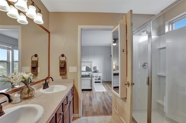 bathroom featuring vanity, tile patterned flooring, a healthy amount of sunlight, and an enclosed shower