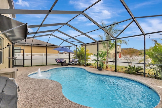 view of pool with a lanai, pool water feature, and a patio