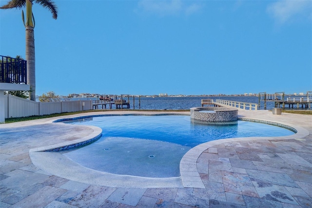 view of swimming pool with an in ground hot tub, a water view, and a patio