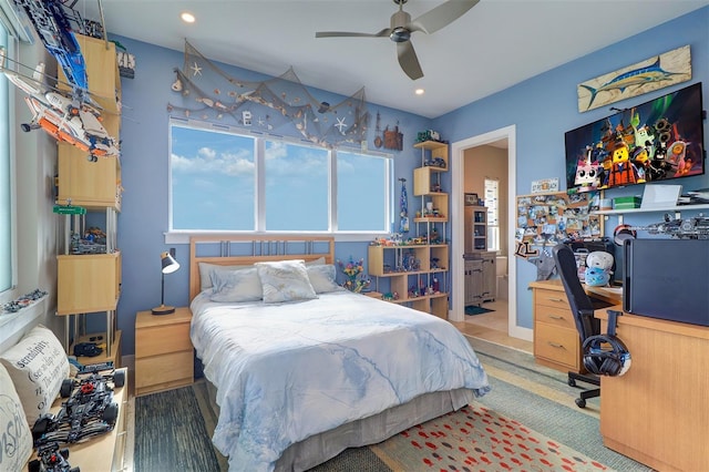 bedroom featuring hardwood / wood-style floors, connected bathroom, and ceiling fan