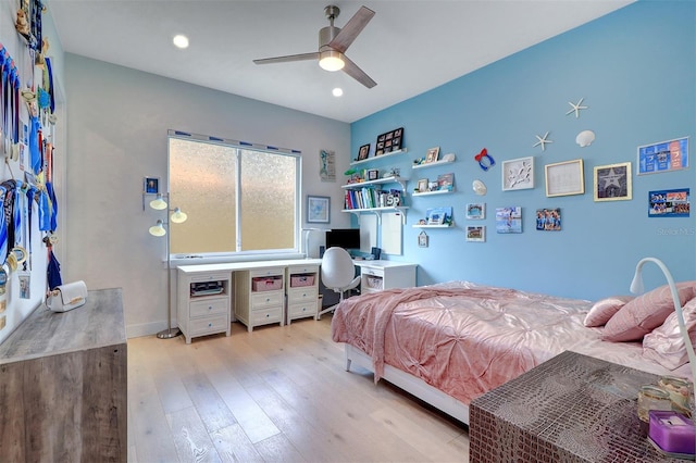 bedroom with ceiling fan and light hardwood / wood-style flooring