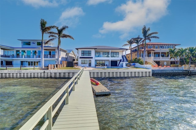 view of dock featuring a balcony and a water view