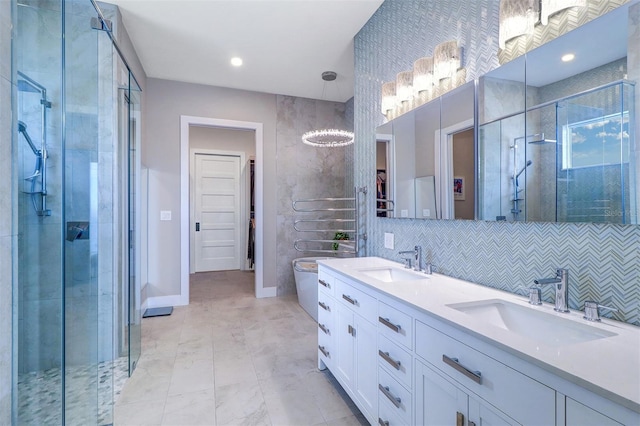 bathroom featuring vanity, decorative backsplash, and walk in shower