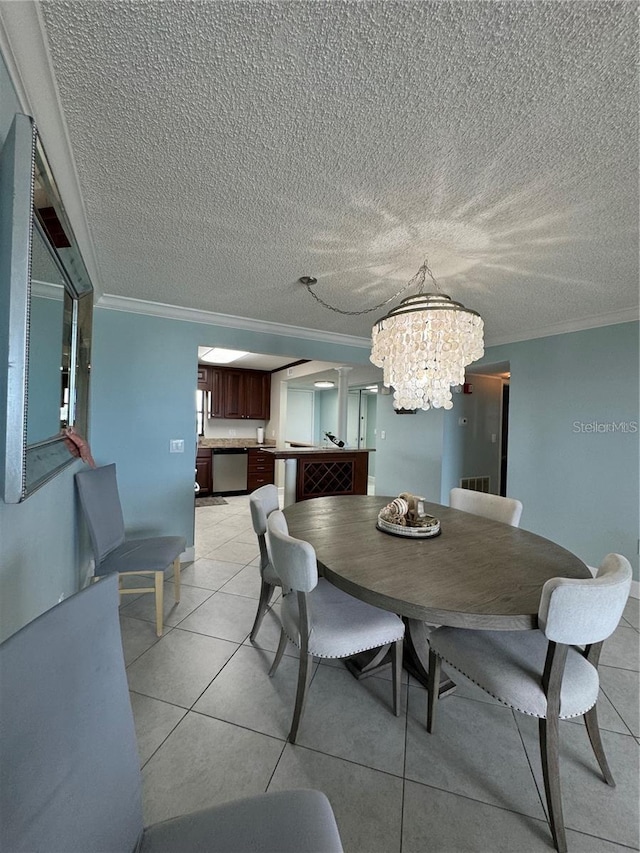 dining area featuring light tile patterned floors, ornamental molding, and a chandelier