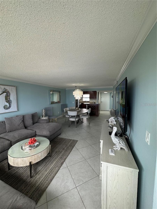 living room with a textured ceiling, light tile patterned floors, crown molding, and a chandelier