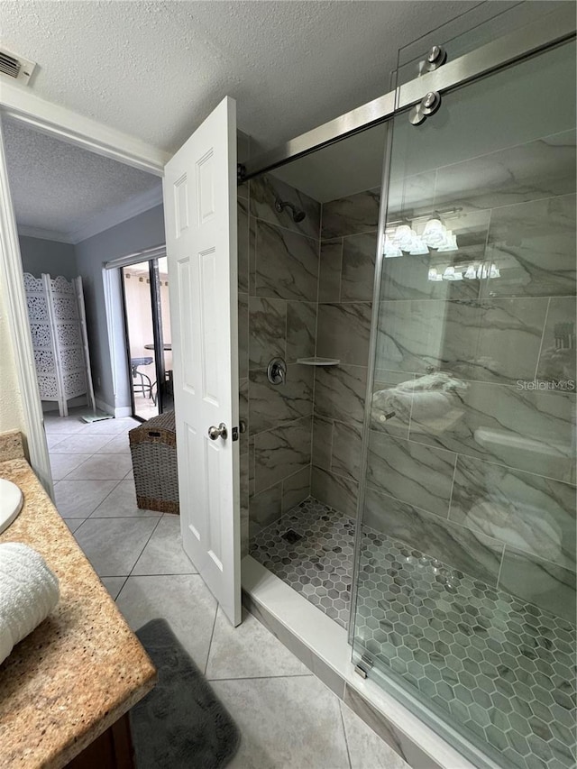 bathroom with a shower with shower door, a textured ceiling, vanity, and ornamental molding