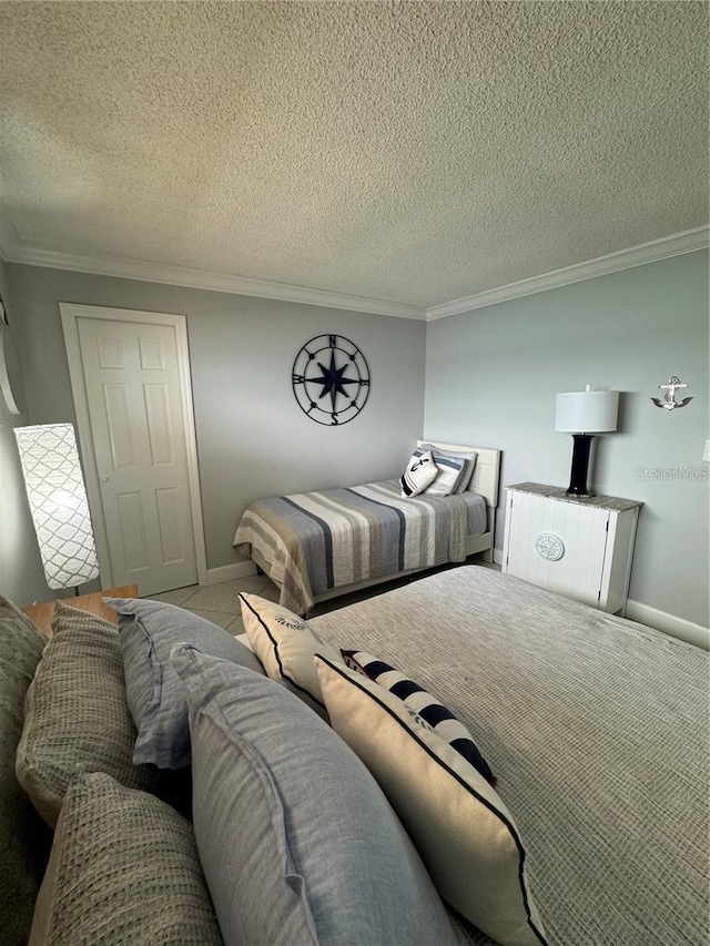 bedroom featuring a textured ceiling and ornamental molding