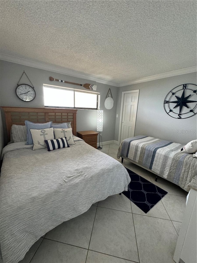 bedroom featuring light tile patterned floors, crown molding, and a textured ceiling