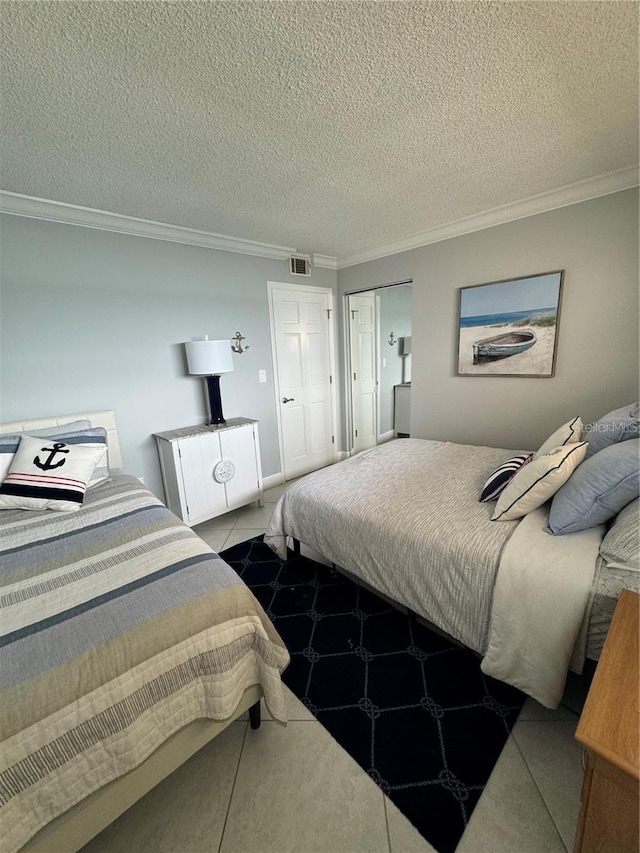 tiled bedroom featuring a textured ceiling and crown molding