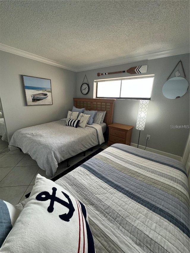 bedroom with tile patterned floors, ornamental molding, and a textured ceiling