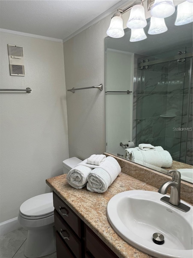 bathroom featuring toilet, vanity, tile patterned floors, crown molding, and a shower with shower door