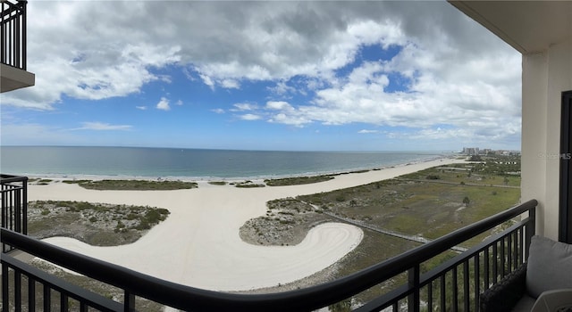 balcony with a beach view and a water view