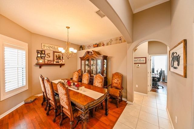 dining space featuring a notable chandelier and light wood-type flooring