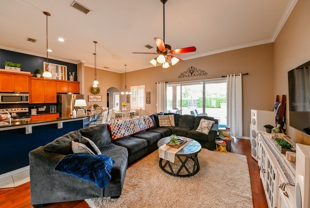 living room with sink, ceiling fan, ornamental molding, and dark wood-type flooring