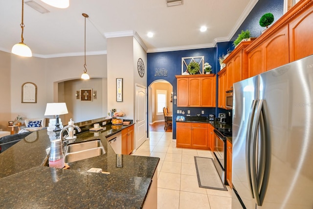 kitchen featuring hanging light fixtures, sink, light tile patterned floors, ornamental molding, and stainless steel appliances