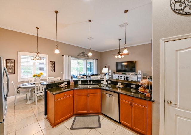 kitchen with sink, light tile patterned floors, dark stone counters, and stainless steel appliances