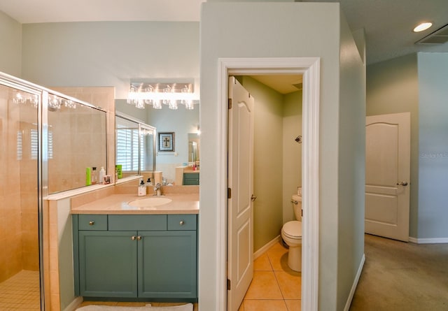 bathroom featuring vanity, toilet, a shower with door, and tile patterned flooring