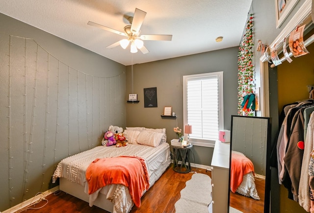 bedroom with ceiling fan and dark wood-type flooring