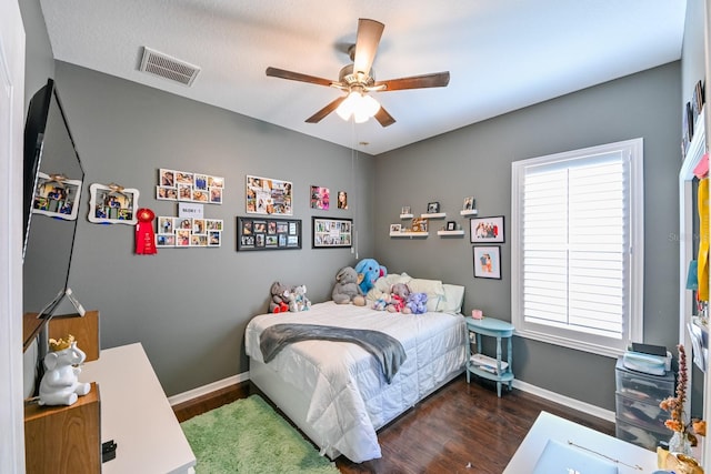 bedroom with dark hardwood / wood-style floors and ceiling fan