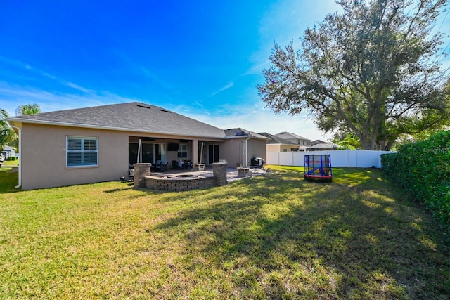 back of house with a patio area and a yard