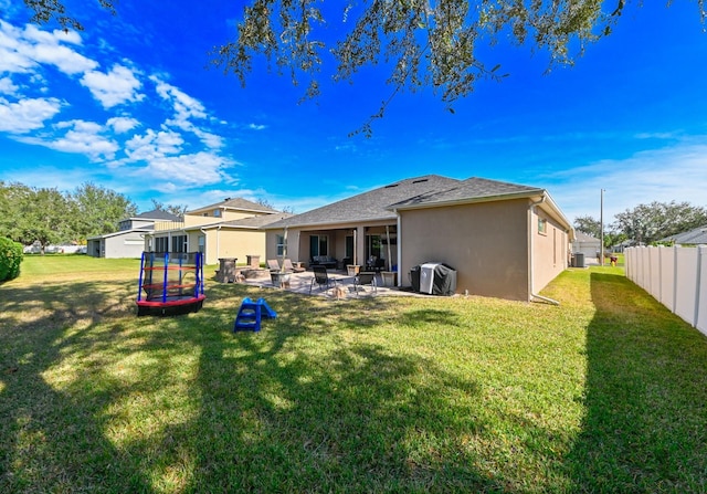 rear view of property with a patio area and a yard