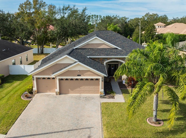 view of front of house with a garage and a front lawn