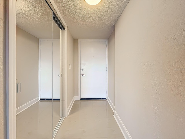 corridor featuring a textured ceiling