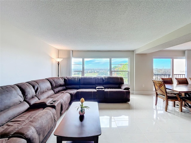 tiled living room with a healthy amount of sunlight and a textured ceiling