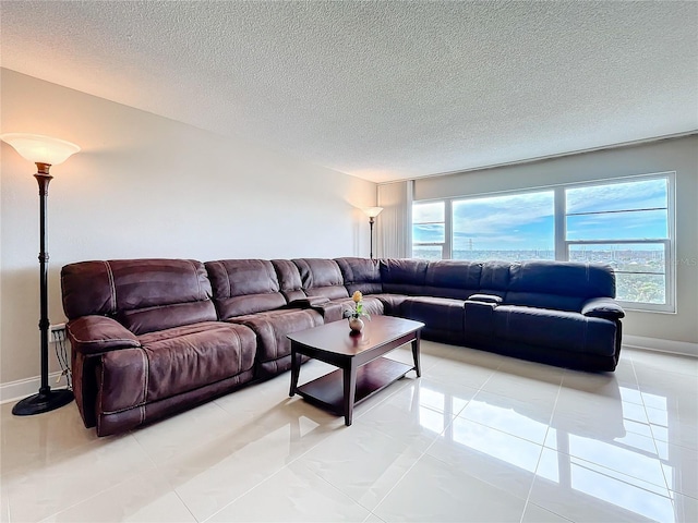 living room with light tile patterned floors and a textured ceiling