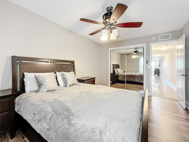 bedroom with a closet, ceiling fan, and hardwood / wood-style flooring