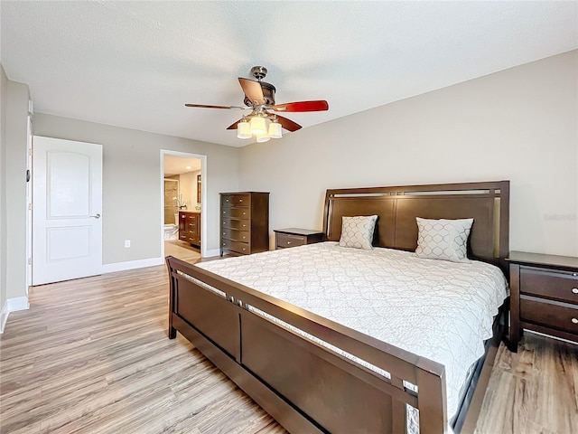 bedroom featuring ceiling fan, light wood-type flooring, and connected bathroom