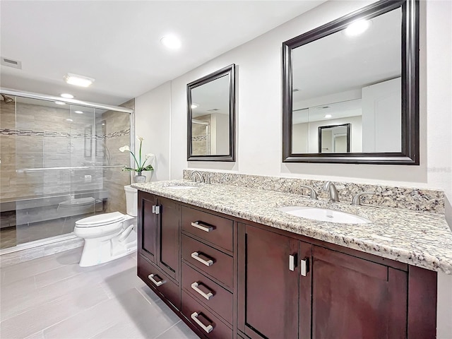 bathroom featuring tile patterned floors, vanity, toilet, and walk in shower