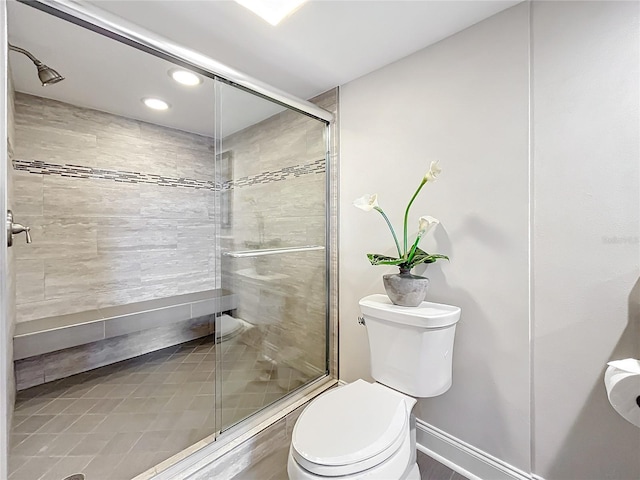 bathroom featuring toilet and an enclosed shower