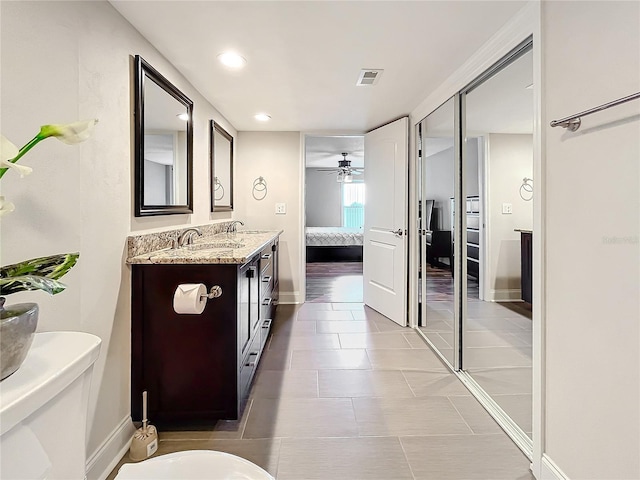 bathroom featuring tile patterned flooring, ceiling fan, and vanity