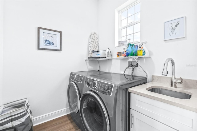 washroom featuring cabinets, dark hardwood / wood-style flooring, separate washer and dryer, and sink