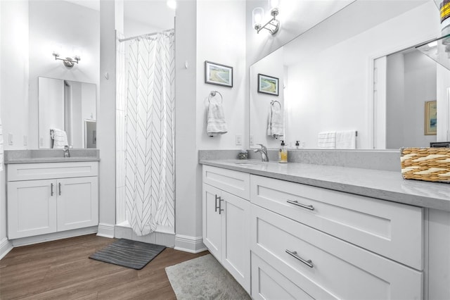 bathroom with a shower with curtain, vanity, and wood-type flooring